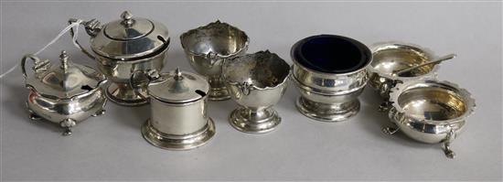 Six assorted silver condiments and two silver egg cups.